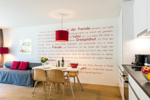 a kitchen and dining room with a table and chairs at Legendär Zermatt in Zermatt