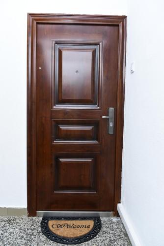a wooden door with a sign in front of it at Lux Apartman Casablanca in Pluzine