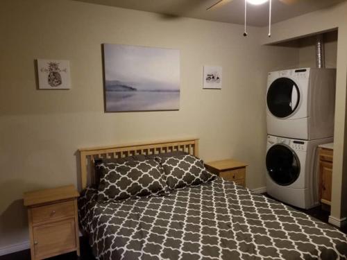 a bedroom with a bed with a black and white comforter at Downtown Cheyenne in Cheyenne
