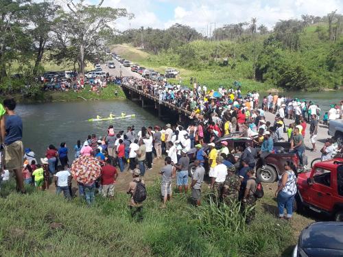 a large crowd of people standing near a bridge at Hidden Haven in Unitedville