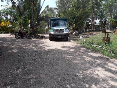 a blue truck is parked on a dirt road at Hidden Haven in Unitedville