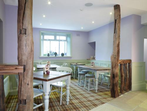 a dining room with wooden tables and chairs at 1885 the Venue - Pub, Restaurant, Rooms & Function House in Halifax
