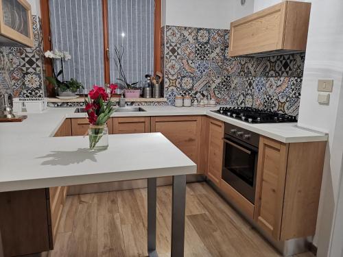a kitchen with a vase of flowers on a counter at Residenza Sant'Angelo in Citta' Sant'Angelo
