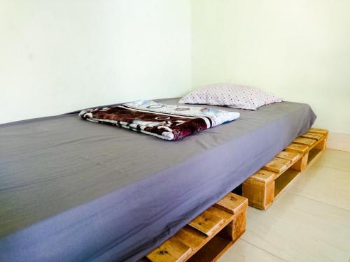 a bed sitting on top of wooden pallets in a room at Srikaloka 12 Kostel - for Female and Couple in Yogyakarta