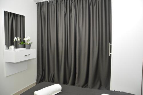 a bedroom with a bed and a curtain at Princess Luxury Suite in Paralia Katerinis