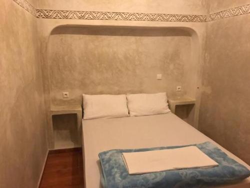 a small bed in a small room with at Tigmi Aftas Mirleft in Mirleft