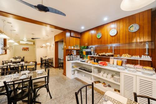 a restaurant with a table and chairs in a room at Infinity Copacabana in Rio de Janeiro