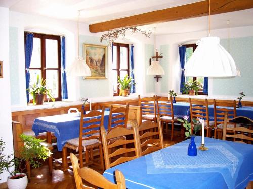 a dining room with blue tables and chairs at Hotel Krone in Gößweinstein
