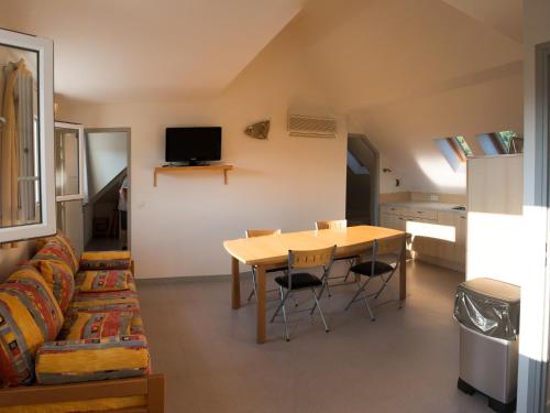 a living room with a table and a couch at Résidence Florimontane in Talloires