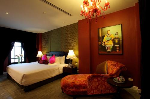 a bedroom with a large bed and a large mirror at Shanghai Mansion Bangkok - SHA Extra Plus in Bangkok
