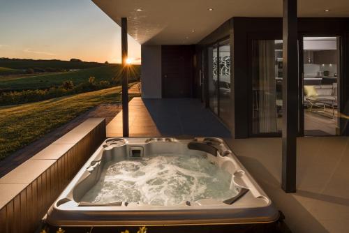 a jacuzzi tub on the balcony of a house at Lochside House Hotel & Spa in New Cumnock