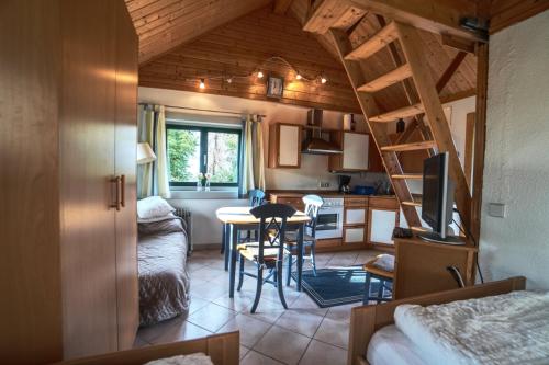 a small kitchen and living room with a ladder in a room at Hof Marienberg, 56340 Osterspai, Deutschland Wanderhütte in Osterspai