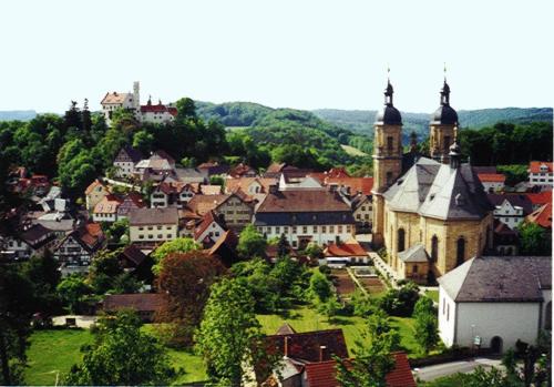 a small town with a church and a city at Hotel Krone in Gößweinstein