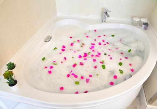a bath tub with pink sprinkles in it at Siete Hotel in Antalya