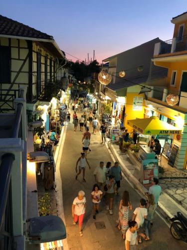 a group of people walking down a street at night at Dimitras home in Vasiliki