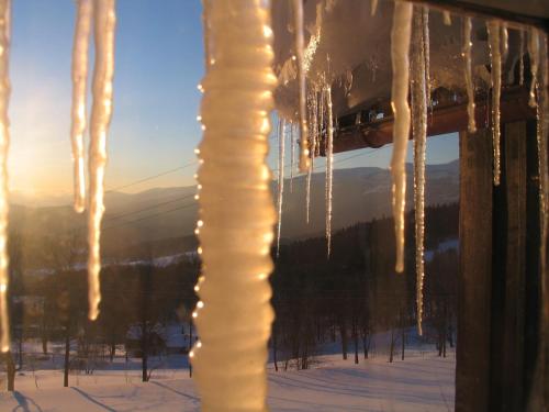 a bunch of icicles hanging from a pole in the snow at Trzy kultury Złoty Widok in Szklarska Poręba