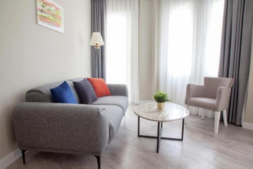 a living room with a couch and a table at Siete Hotel in Antalya
