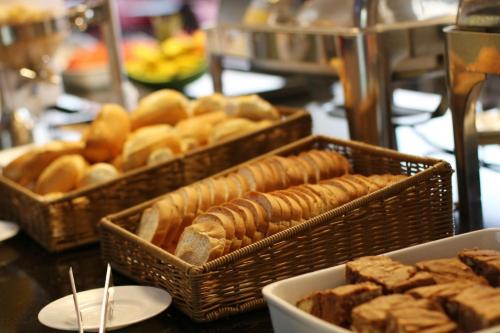 two baskets of bread and pastries on a table at Samba Itaboraí in Itaboraí
