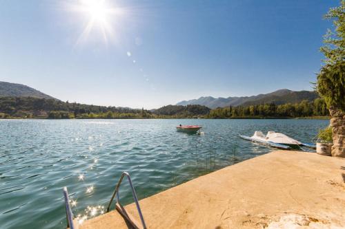 a boat is docked at a dock on a lake at Apartments Barbir in Ploče
