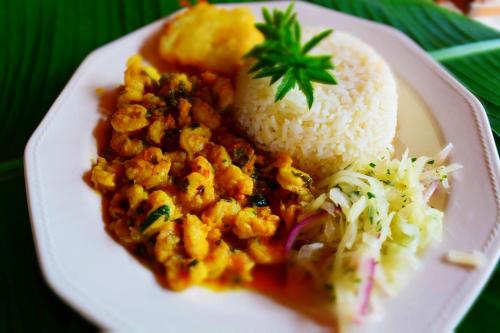 a plate of food with rice at Posada Hannany in Arusí