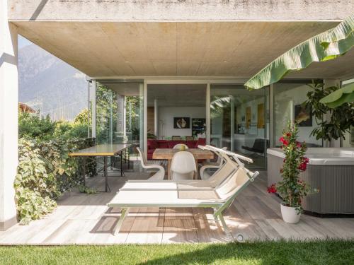 a patio with a table and chairs on a house at Villa Alvarium in Schenna