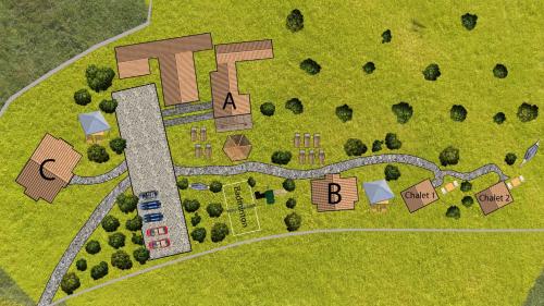 an overhead view of a site plan of a house at Magnolia Resort Chalets in Vişeu de Sus