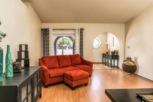 a living room with a red couch and a chair at Bell Villa - Resort Living - Pool - Location - Events in Phoenix