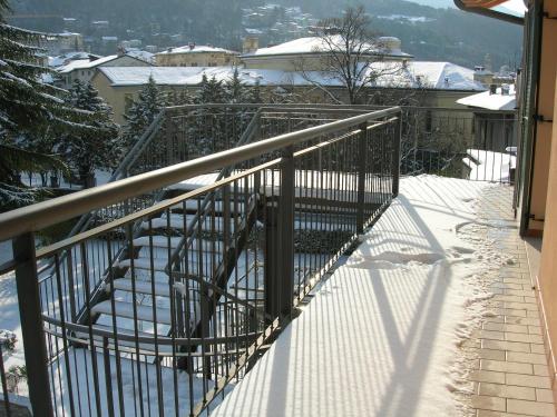 a metal stair case with snow on the ground at Ostello Città di Rovereto in Rovereto
