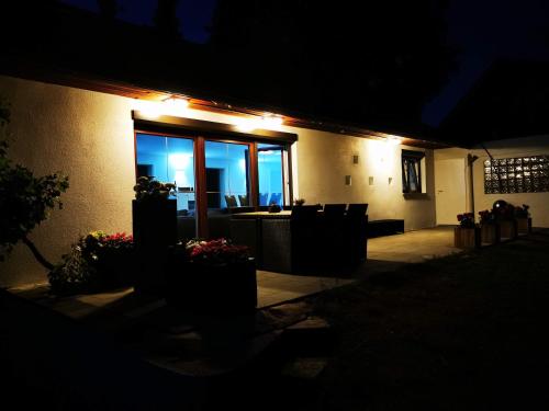 a building with a patio at night with lights at Ferienhaus Oebel in Brüggen in Brüggen