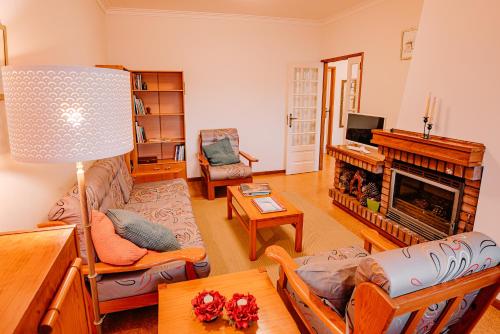 a living room with a couch and a fireplace at Bela Vista in Viana do Castelo