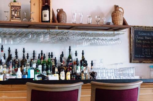 a bar with a lot of bottles of alcohol at Hotel Tadoussac in Tadoussac