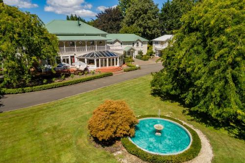 an aerial view of a house with a swimming pool in the yard at Mangapapa Hotel in Havelock North