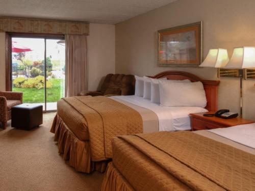 a hotel room with two beds and a window at The Foothills Inn in Rapid City