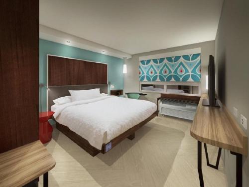 a bedroom with a bed and a tv in it at Tru By Hilton Edinburg in Edinburg