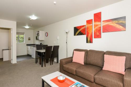 a living room with a couch and a table at Ellena Court Motel in Blenheim