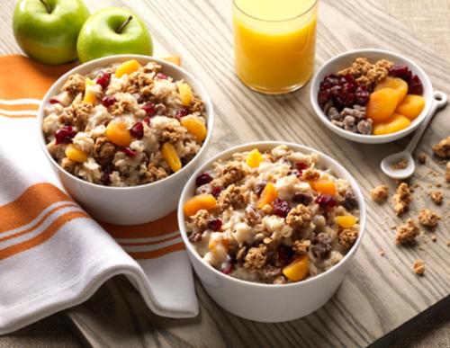 three bowls of oatmeal with fruit and a glass of orange juice at Home2 Suites By Hilton Joplin, MO in Joplin