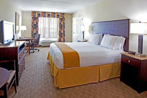 a hotel room with a large bed and a desk at Holiday Inn Express & Suites Columbus at Northlake, an IHG Hotel in Columbus