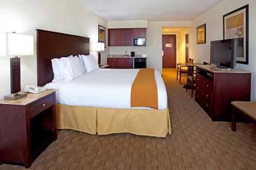 a hotel room with a large bed and a television at Holiday Inn Express & Suites Columbus at Northlake, an IHG Hotel in Columbus
