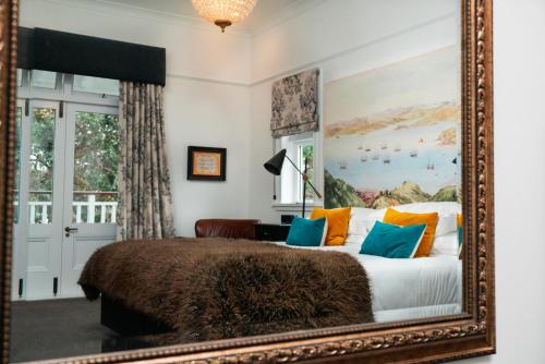 a bedroom with a large mirror and a bed at The Duke Of Marlborough in Russell