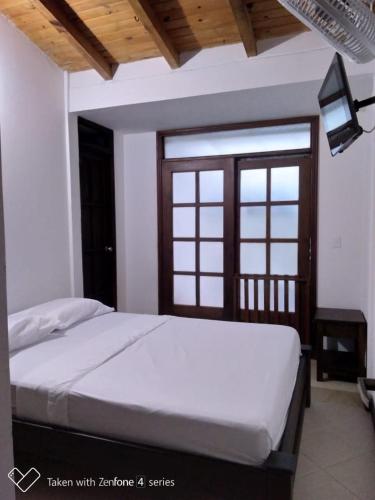 Postel nebo postele na pokoji v ubytování Hostal Suna Vito
