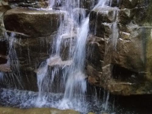 a waterfall in a pool of water at Shan-Yue Hotspring Hotel in Taipei