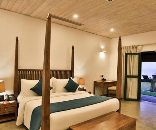 a hotel room with a bed and a tv at Arie Lagoon in Negombo