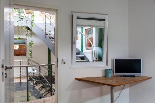 a room with a door and a television on a table at Bergwerksilo Herznach in Herznach