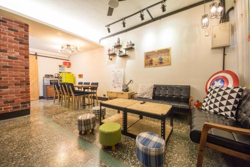 a living room with a couch and a table at 台東市區 童年時光六人包棟民宿 附廚房及電動麻將 in Taitung City