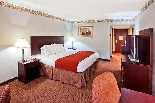 a hotel room with a bed and a flat screen tv at Holiday Inn Express Atlanta W (I-20) Douglasville, an IHG Hotel in Douglasville