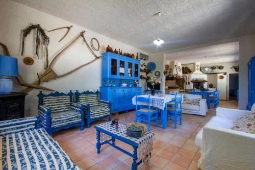 a blue living room with blue chairs and tables at Villa Baglio in Marsala