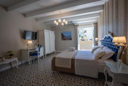 Postel nebo postele na pokoji v ubytování Sui Generis Tropea Luxury Rooms