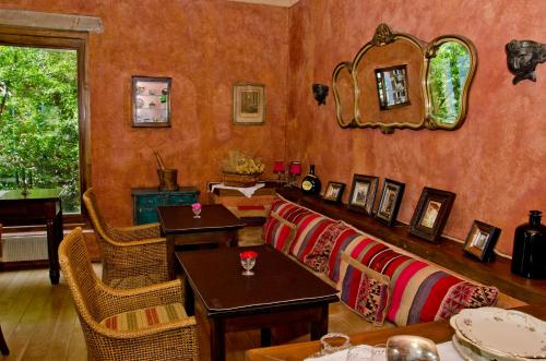 a living room with chairs and tables and a mirror at Luma Casa De Montaña in Villa La Angostura