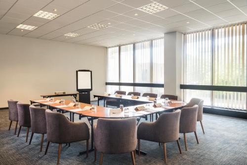 a conference room with a large table and chairs at Mercure Bedford Centre Hotel in Bedford