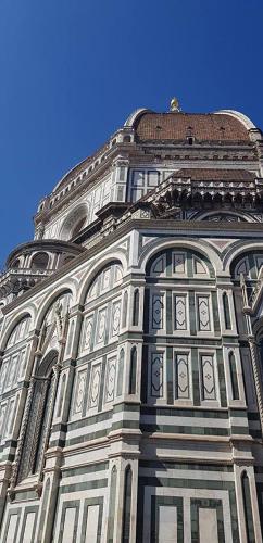 a tall building with a blue sky in the background at B&B Il Glicine in Montefollonico